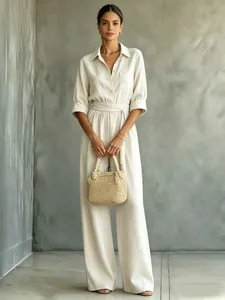 Elegant beige wide-leg linen jumpsuit with a shirt collar and belted waist for summer