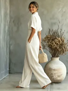 Detail view of a cream short sleeve wide leg jumpsuit for women in a stylish setting