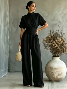Elegant black short sleeve wide leg jumpsuit for women in a stylish indoor setting