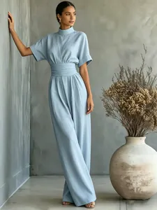 Elegant detail of light blue high-neck short-sleeve wide-leg jumpsuit on model