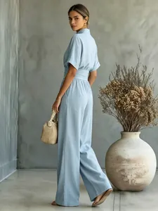 Elegant light blue short sleeve wide-leg jumpsuit with high waist detail.