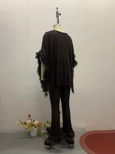 Back view of shimmering black sequined poncho and flared pant set on mannequin