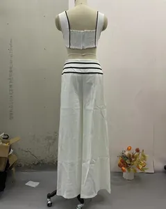 Rear view detail of white fashion two-piece set with black stripes and flared pants
