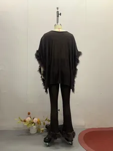 Back view of elegant black women's two-piece set with plush faux fur trim on mannequin.