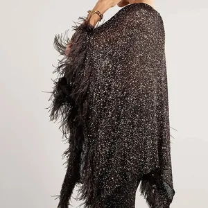 Macro view of luxurious sequin fabric and ostrich feather fringe on a stylish top