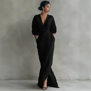 Elegant black V-neck maxi dress with pleated waist detail shown on professional model
