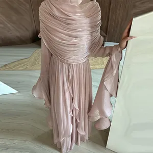 Elegant pink pleated maxi dress featuring shimmering fabric and layered ruffle cuff detailing
