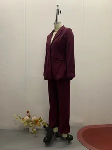 Seitenansicht eines eleganten weinroten zweiteiligen Anzugsets für Damen auf Schaufensterpuppe