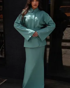 Elegant teal green three-piece set featuring long sleeve lapel blouse and maxi skirt.