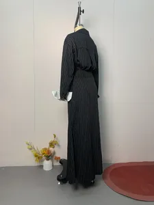 Back view detail of black pinstripe shirt and matching maxi skirt set on mannequin