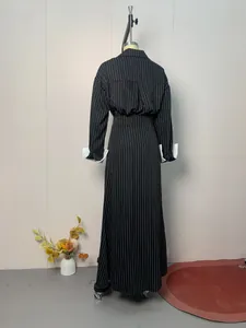 Back silhouette view of a pinstriped long-sleeved shirt and matching maxi skirt set