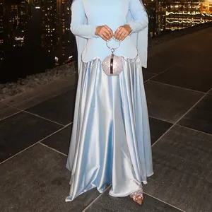 Elegant light blue long dress set with waist-cinching design and crystal bag detail