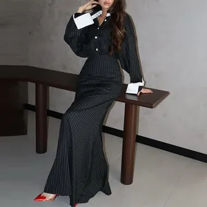 Elegant pinstriped two-piece set featuring a button-up shirt and long fishtail skirt