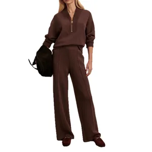 Elegant brown knitted two-piece set with half-zip pullover and wide-leg trousers.