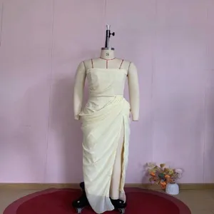 Pale yellow strapless evening dress with elegant pleated wrap and high slit on mannequin