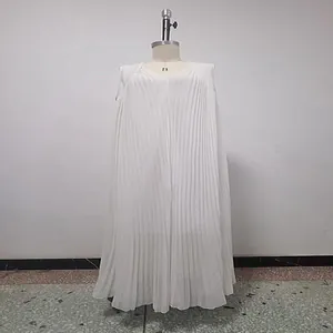 Detail of white pleated maxi dress with loose oversized fit and flowing fabric