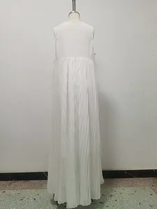 Back view of white sleeveless pleated maxi dress with flowing oversized hem