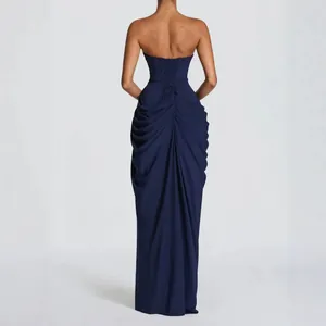 Detailed back view of navy blue strapless evening gown with lace-up corset and ruching