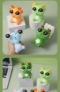 Close-up of popping eyes dragon squeeze toys in various vibrant colors for stress relief.