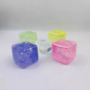 Close-up of colorful glitter stress relief cubes with semi-transparent ice-like texture.