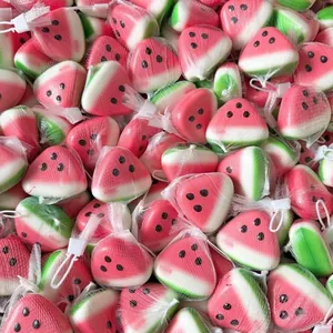 Macro view of multiple watermelon squishy toys packed in white mesh bags.