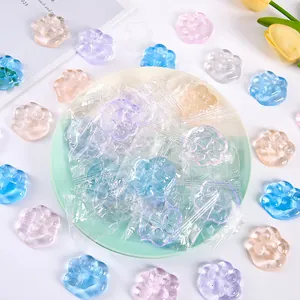 Colorful translucent cat paw squishy toys for stress relief, presented on a decorative plate