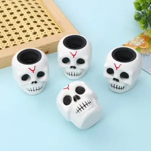 Detailed view of white skull squeeze toys on blue background for Halloween decor