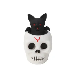 Close-up detail of a Halloween skull squeeze toy with a pop-up black bat surprise