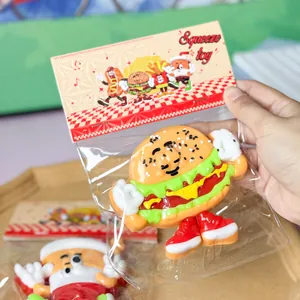 Detail of a cute cartoon hamburger stress relief toy in clear plastic packaging.