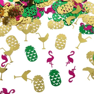 Close-up of colorful flamingo and pineapple party confetti for beach decor