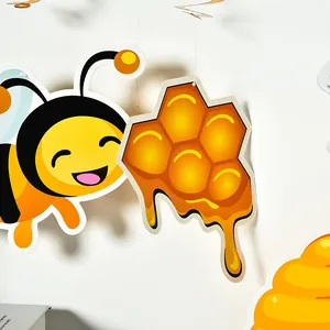 Detailed view of cute cartoon bee and golden honeycomb drip spiral party hanging decorations