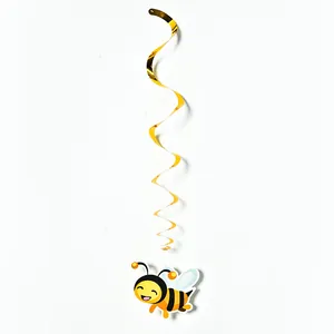 Detail view of a cute cartoon bee pendant attached to a golden spiral party streamer