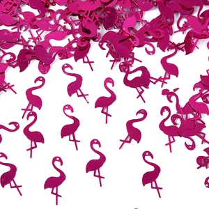 Macro view of metallic fuchsia flamingo shaped confetti for Hawaii beach party decor
