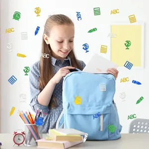 Glittery school-themed confetti with ABC and pencil shapes on a student desk
