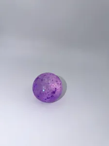 Detailed view of a purple aurora sequin stress ball with a sparkling glitter finish.