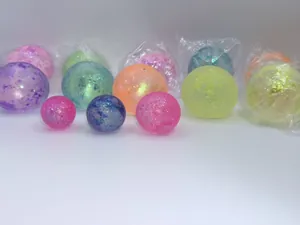 Glitter squeeze stress balls in various colors and sizes for sensory decompression play.