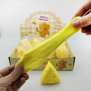 Detail view of a soft yellow cheese squishy toy being stretched for maximum stress relief