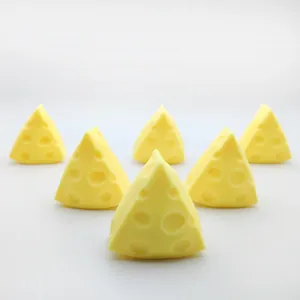 Triangular cheese-shaped squishy toys for stress relief on a clean white background.