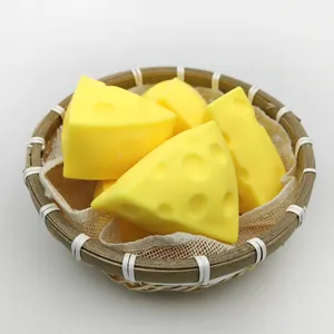 Yellow realistic cheese-shaped stress relief squishy toys displayed in a rustic woven basket.