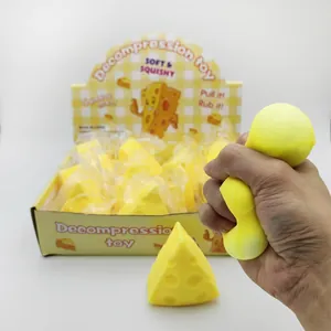 Close-up of a hand squeezing a yellow cheese-shaped soft squishy decompression toy for stress relief