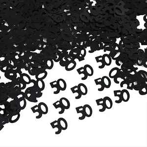 Close-up view of black number 50 confetti for 50th birthday party table decoration