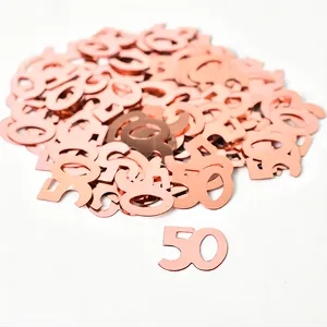 Detailed view of shiny rose gold number 50 metallic confetti for party table decor