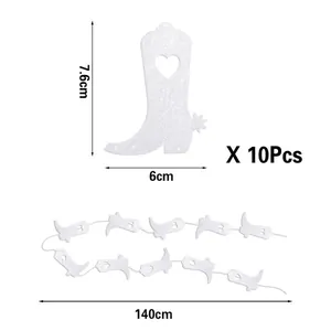 Close-up view of white glittery cowboy boot banner with heart cutout for disco party decor
