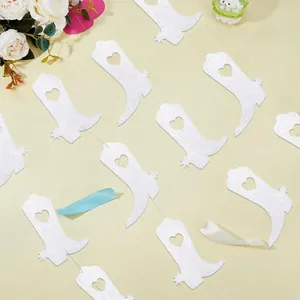 Close-up detail of white glittery cowboy boot garland for Western disco theme party decor