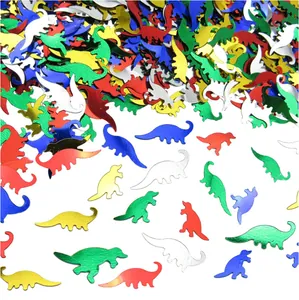 Close-up of colorful Jurassic dinosaur party confetti scattering on white background