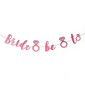 Close-up of rose gold glitter Bride to be banner with diamond ring party decoration
