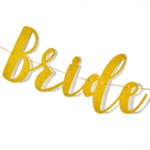 Detailed view of a shimmering gold glitter Bride script banner for wedding party decoration