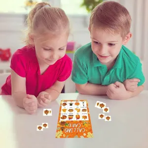 Children playing with cartoon turkey harvest Thanksgiving bingo game cards at a table