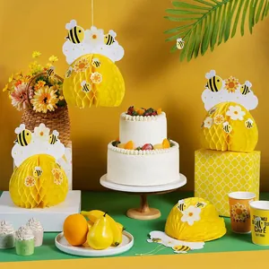Bee themed honeycomb paper hanging ornaments and stickers for kids birthday party decor.