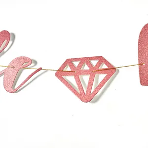 Close-up of rose gold glitter birthday banner with diamond shape detail.